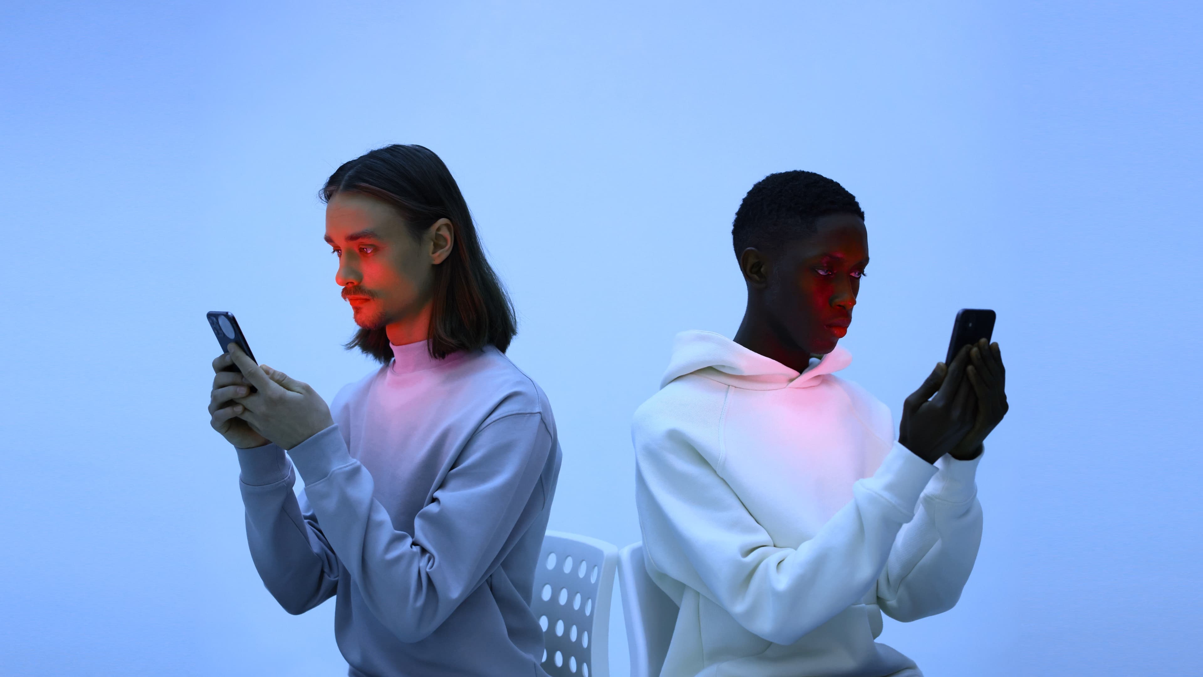 Two men using mobile phones