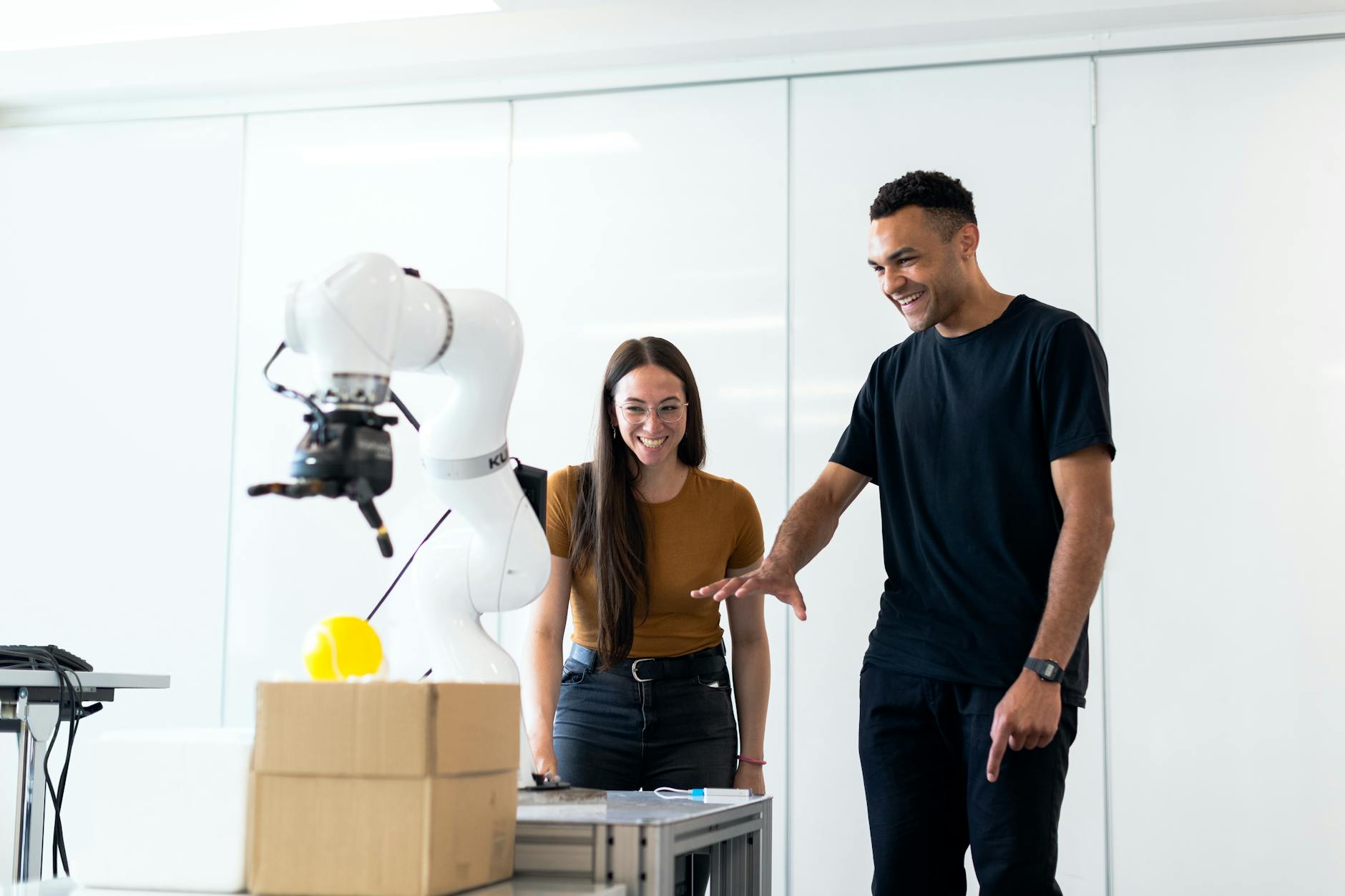 Team testing an automation system with a robotic arm