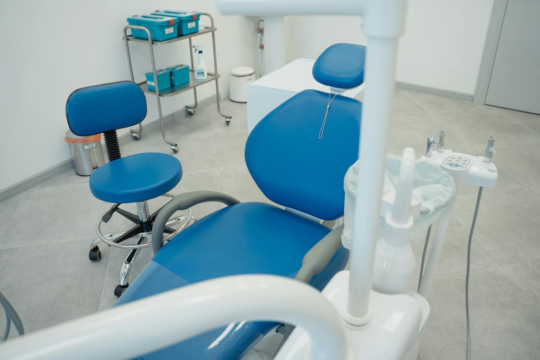 Modern dental clinic with blue chairs and equipment