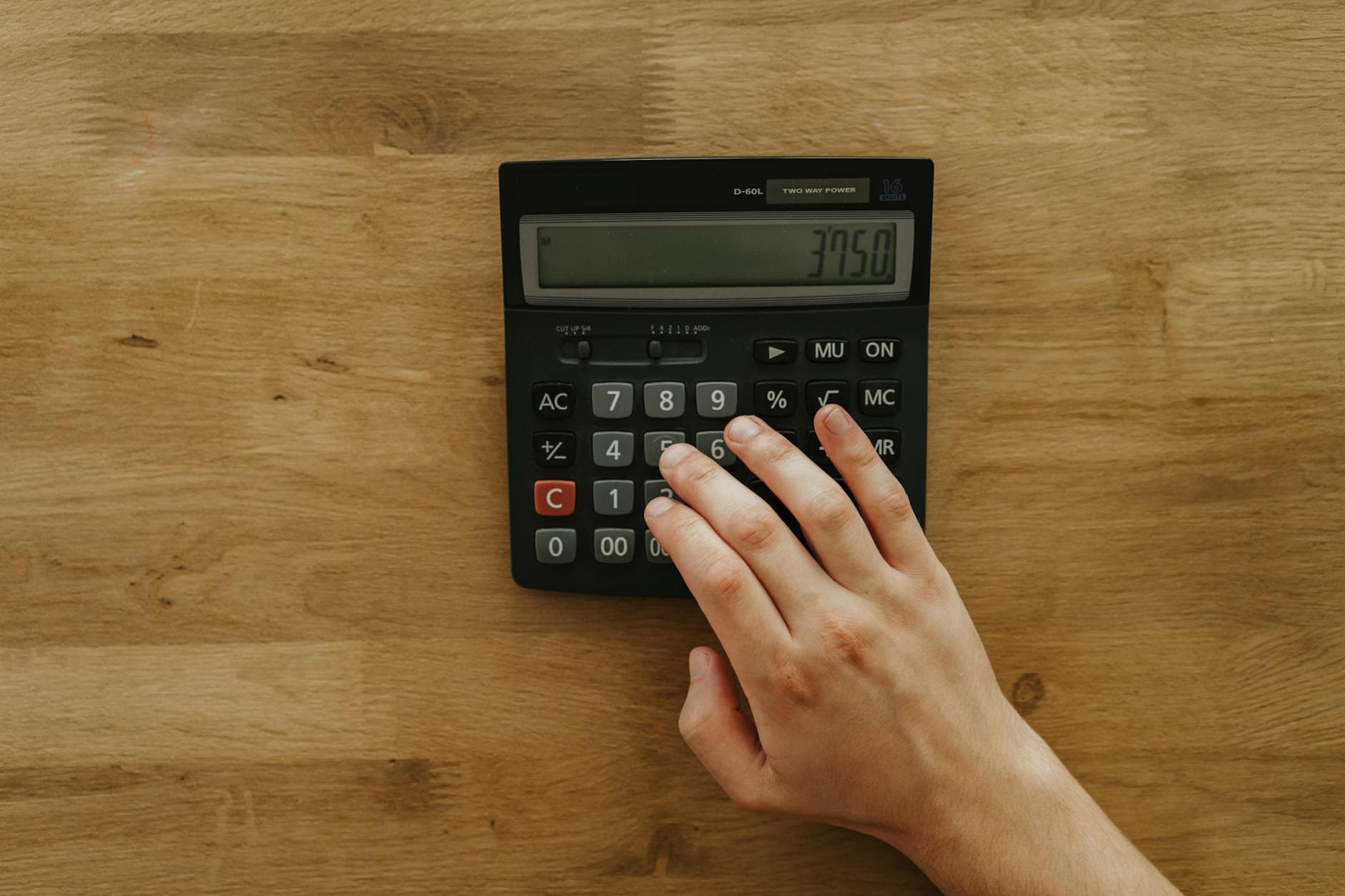 Calculator on a wooden desk for financial planning