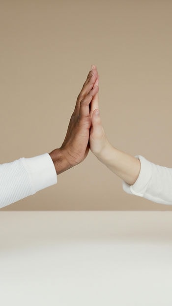 Two hands of different backgrounds embracing