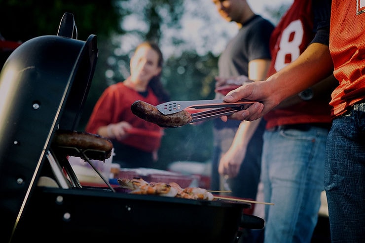 Grilling sausages at a trade-show tailgate