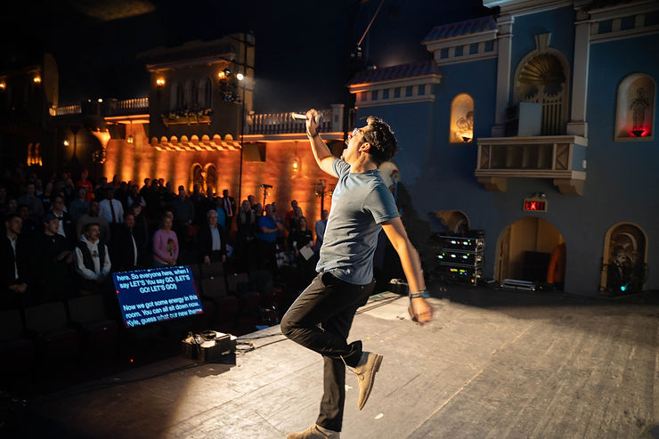 Kyle Senger, Unalike Marketing, jumping on stage at an event