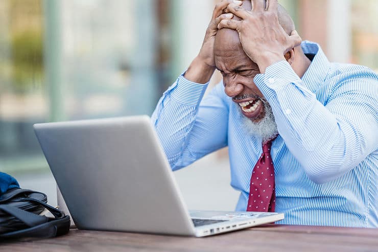 Man angry at his laptop computer