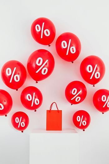 Shopping bag with percentage-off balloons — agency cost savings