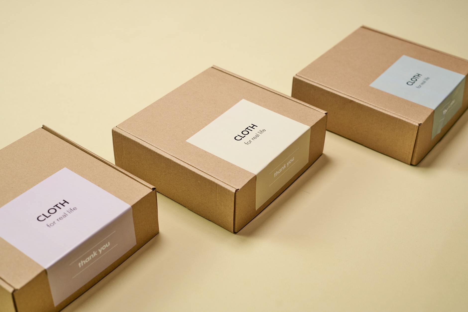 Minimal branded packages on a yellow background