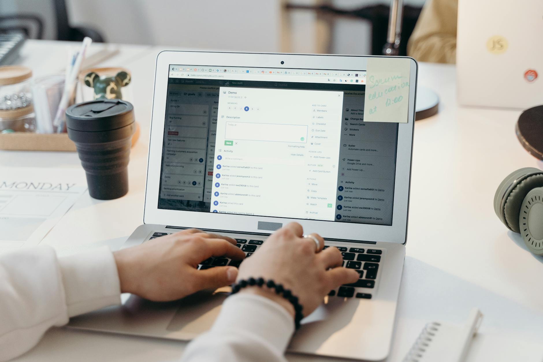 Person typing on a laptop in a bright office