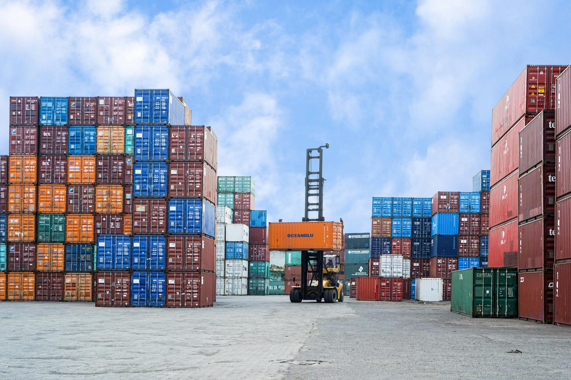 Shipping containers and forklift in a logistics yard