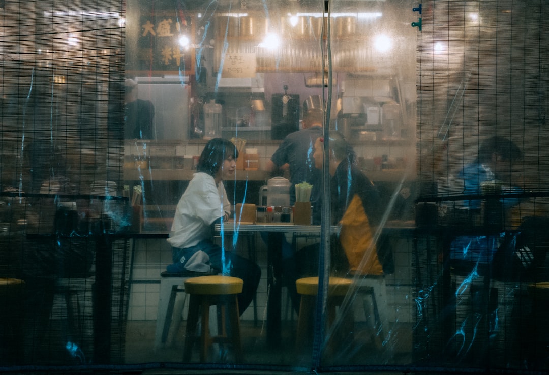 a group of people sitting at a table in a restaurant